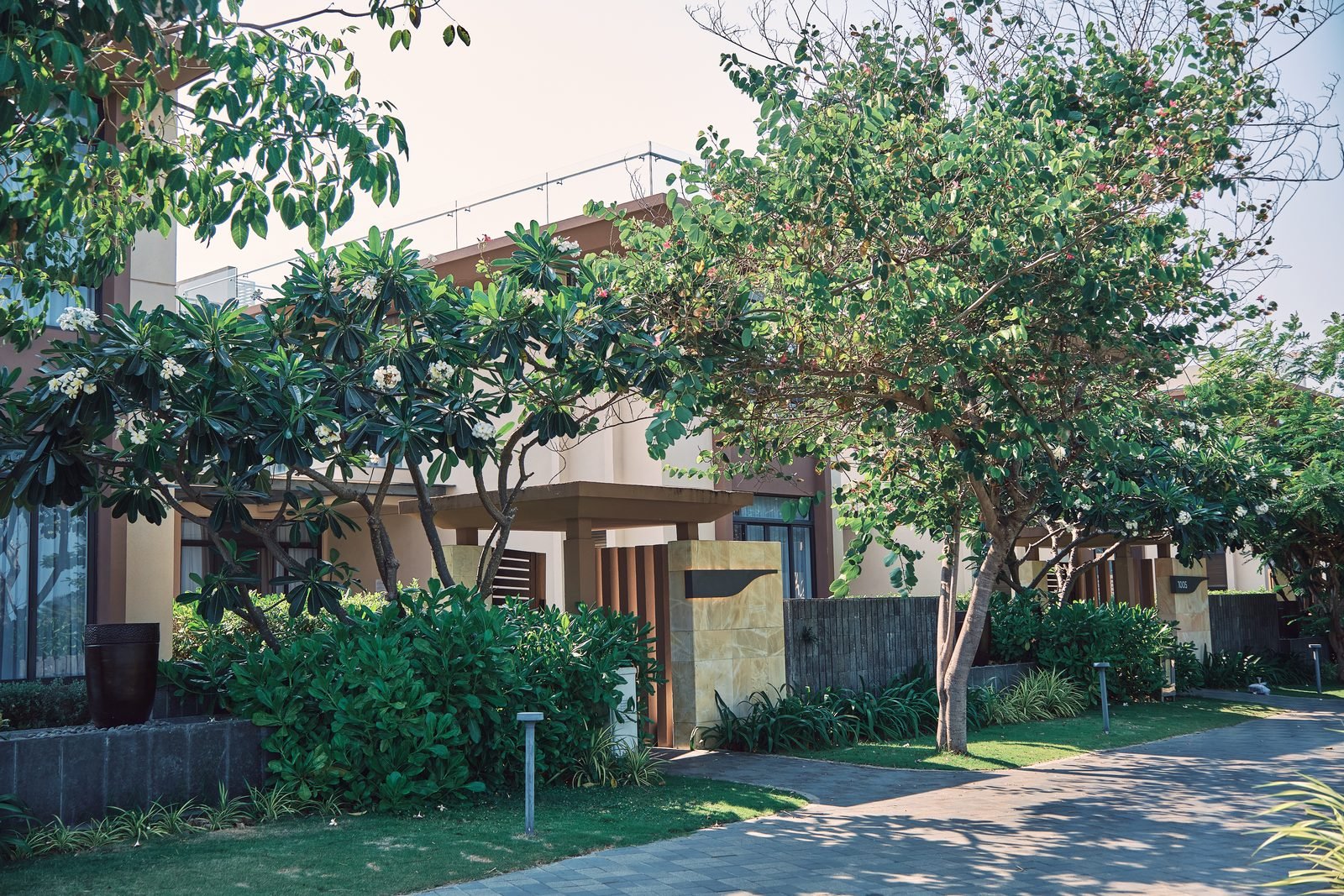 Frangipani-shaded entrance of the Deluxe Pool Villa