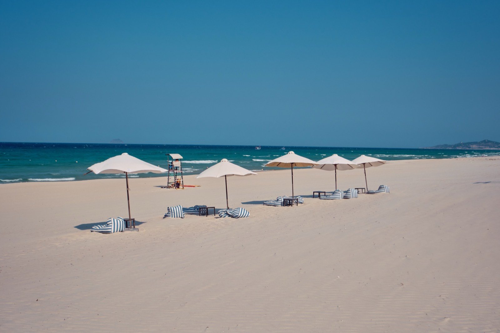 Umbrellas and loungers on the beach at golden hour