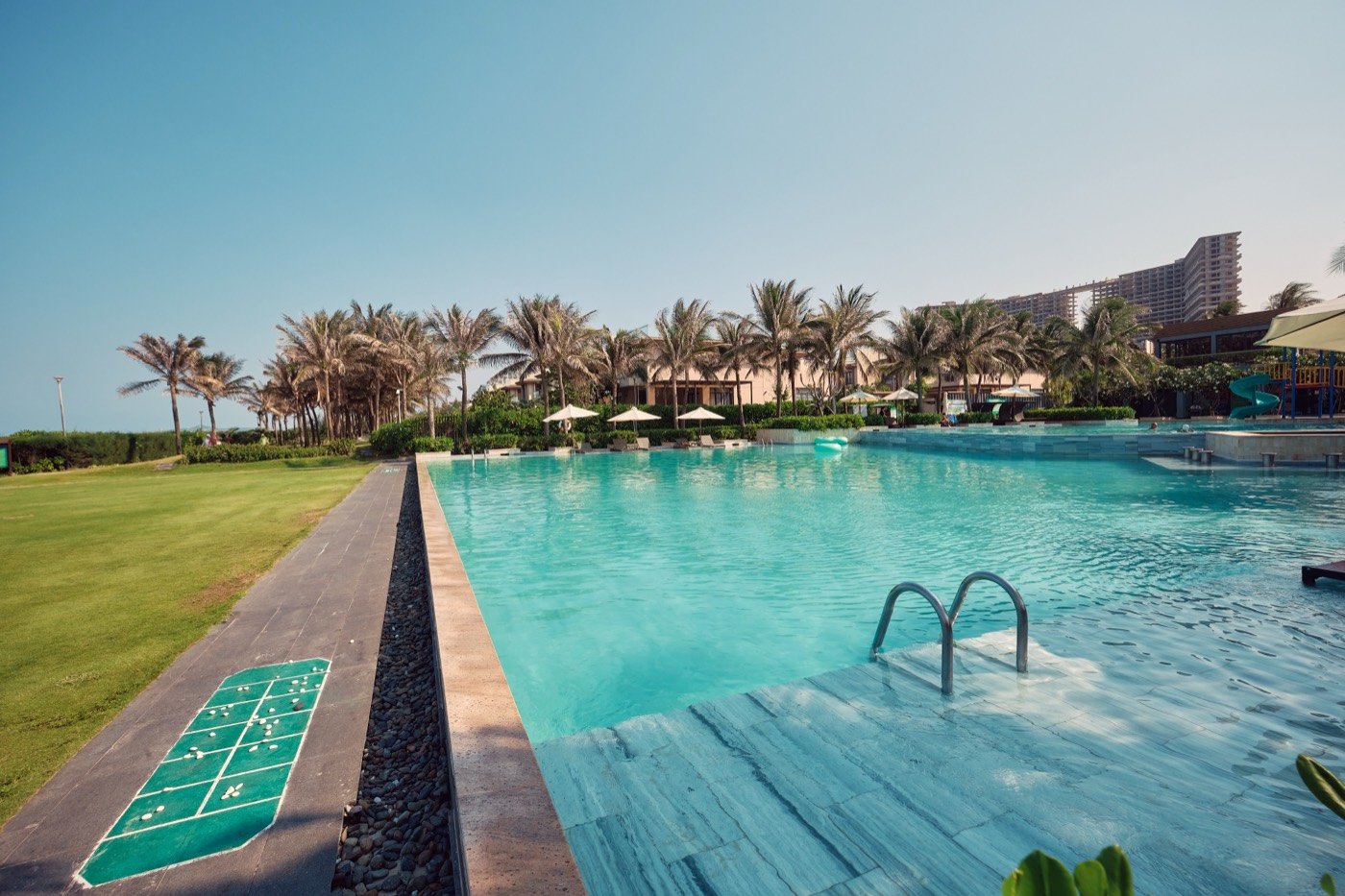 Lap pool beside a green lawn