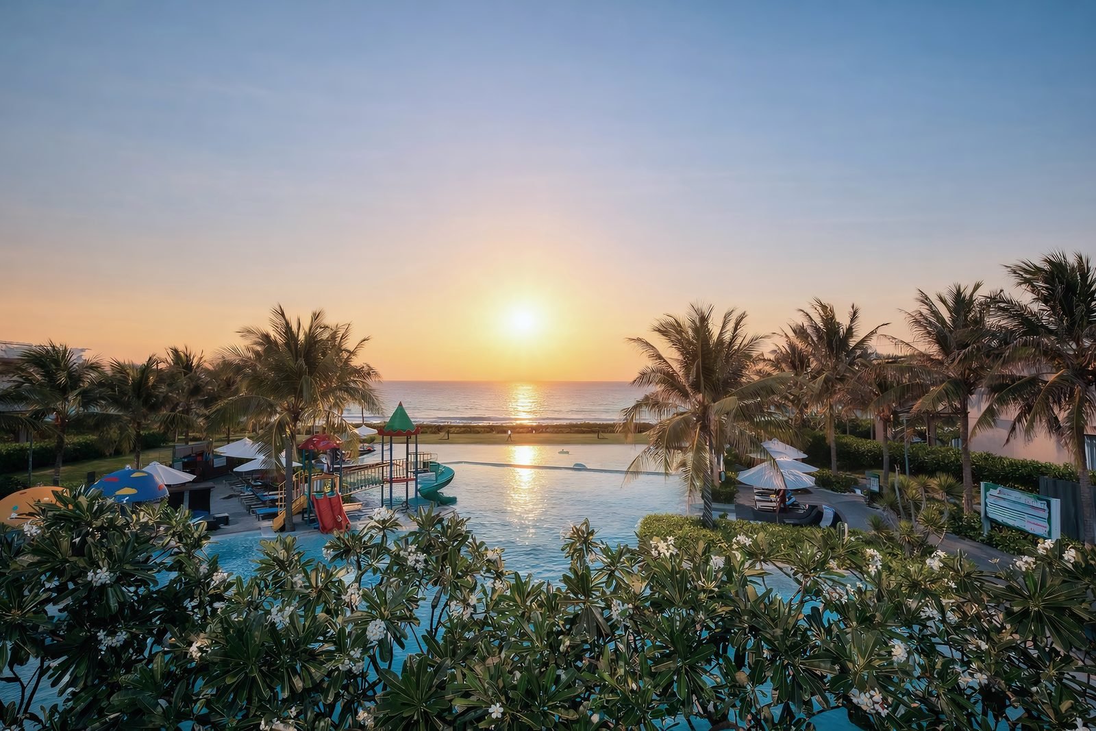 Sunrise over the resort infinity pool and ocean